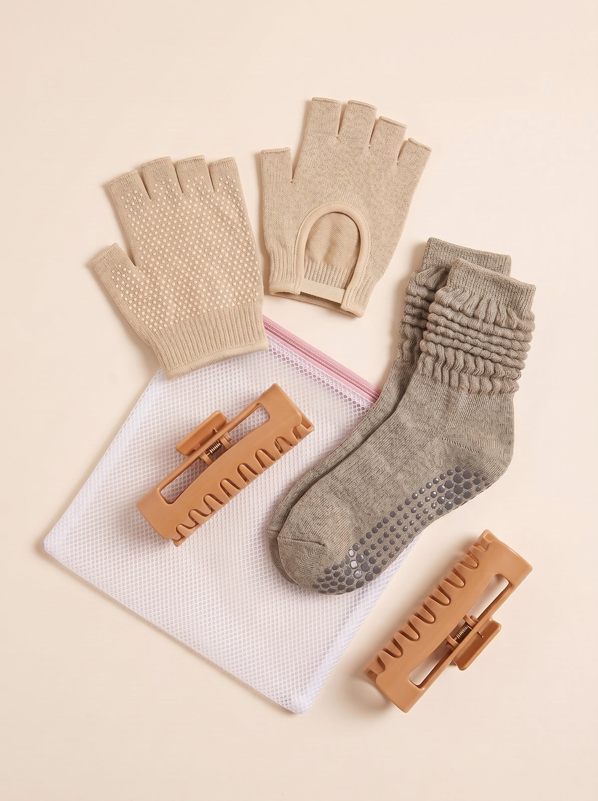 The RKKN Set in Oat: gloves, grip socks, SoftClip and wash bag, laid flat
